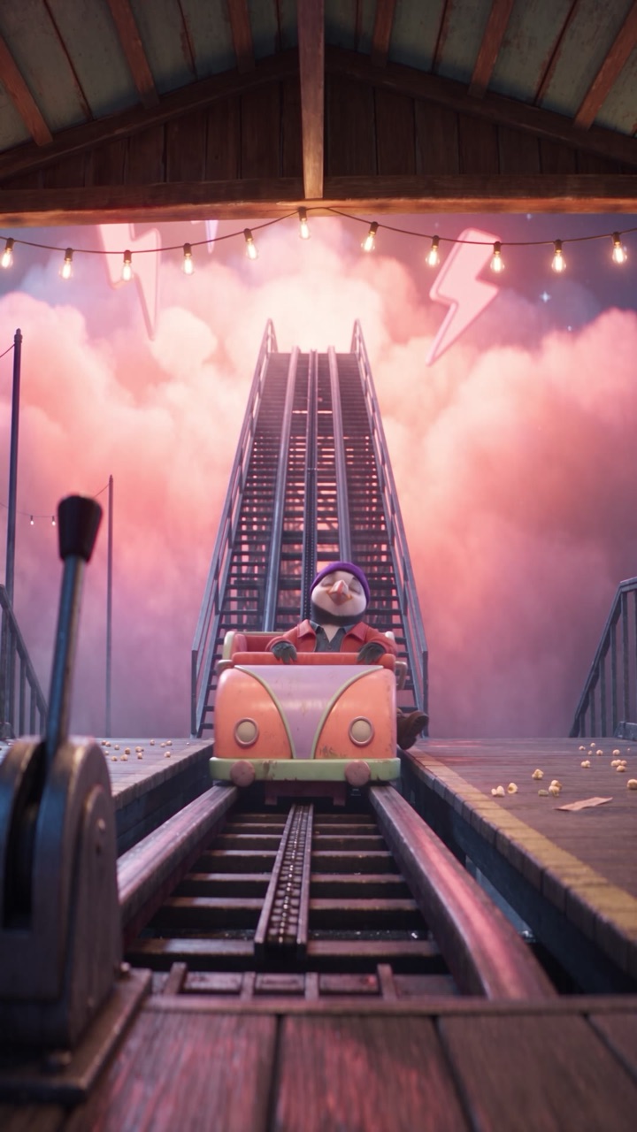 A roller coaster track rising into pink sunset clouds